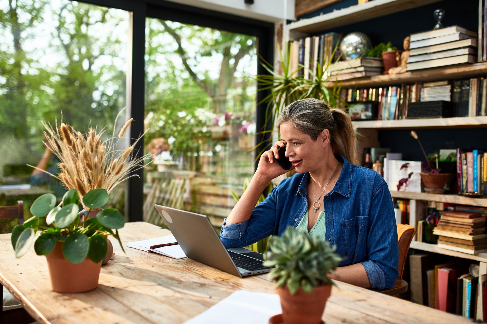 Mature woman using smartphone and working from home, connected, technology, efficiency